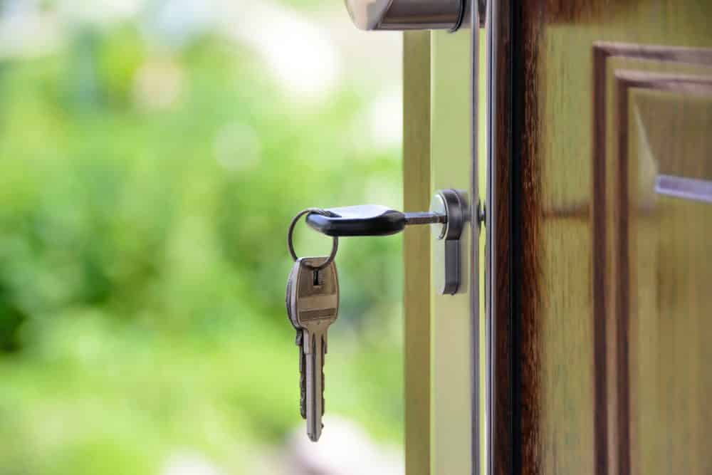 Keys in the lock of a new home bought by a first time buyer