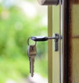 Keys in the lock of a new home bought by a first time buyer