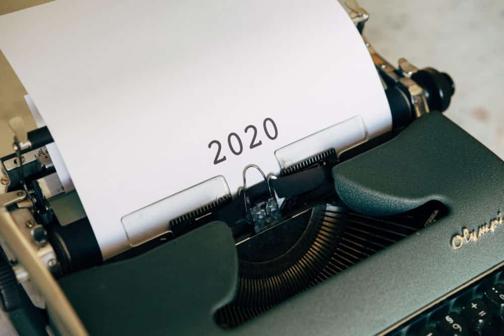 A typewriter with a piece of paper with 2020 typed on it