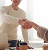 A contractor shaking hands with a contractor mortgage broker after a successful meeting