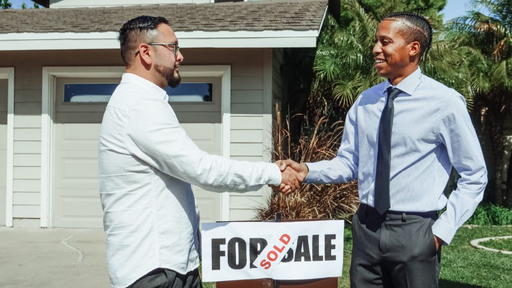 Two men shaking hands following a mortgage deal