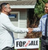 Two men shaking hands following a mortgage deal