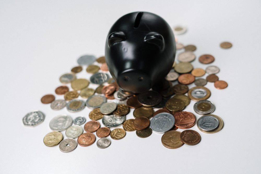 A Piggy Bank with coins scattered around